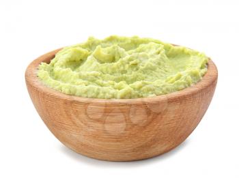 Bowl with tasty guacamole on white background�