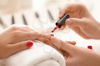 Young woman getting professional manicure in beauty salon, closeup�