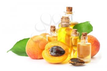 Bottles of apricot essential oil on white background�