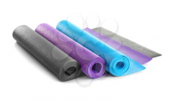 Different yoga mats on white background�
