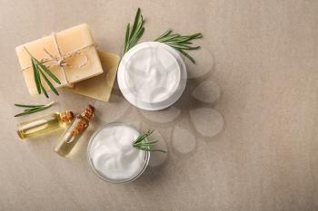Flat lay composition with body cream, soap and essential oil on light background�