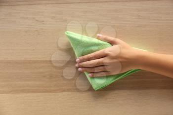Woman cleaning wooden surface, top view�