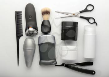 Flat lay composition with shaving accessories and cosmetics for men on white background�