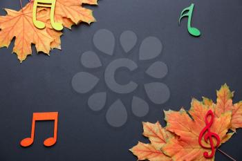 Beautiful autumn leaves with musical notes on dark background�