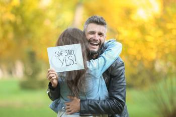 Happy couple after making proposal in autumn park�