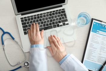Female doctor using computer at workplace. Health care concept�