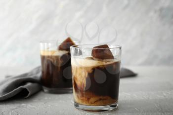Glass of cold coffee on light table�