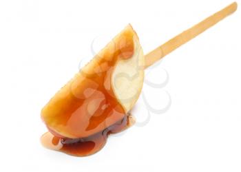 Apple wedge with sweet sauce on white background�