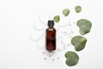Bottle of eucalyptus essential oil on white background�