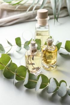 Bottles of eucalyptus essential oil on table�