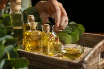 Woman with bottles of eucalyptus essential oil, closeup�