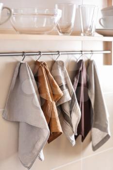 Clean kitchen towels hanging on rack�