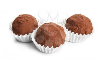 Tasty chocolate truffles on white background�