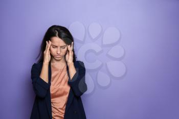 Stressed young woman on color background�