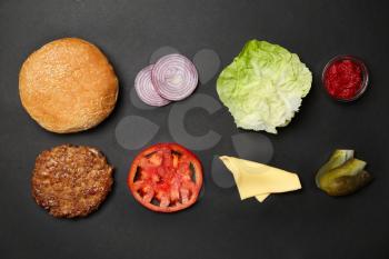 Ingredients for burger on black background, flat lay�