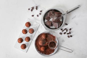Tasty sweet truffles with cacao powder and chocolate on light table�