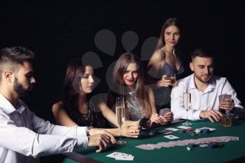 Group of people playing poker in casino�