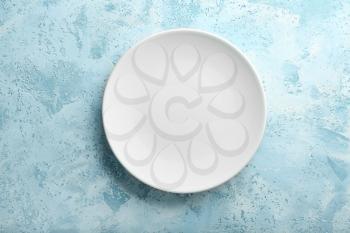 Clean empty plate on color background�