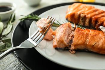 Pieces of tasty grilled salmon on plate, closeup�