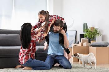 Happy family playing after moving into new house�