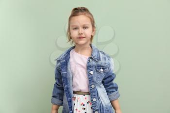 Portrait of stylish little girl on color background�