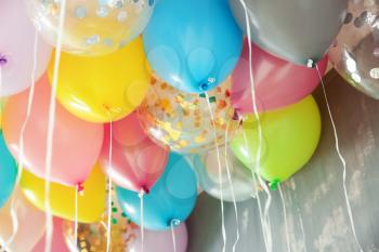 Many colorful balloons under ceiling in room�