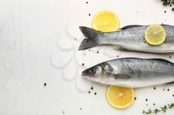 Tasty fresh seabass fish with spices on white background�