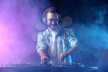 Male DJ playing music in club�