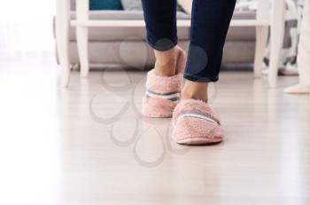 Young woman in slippers at home�