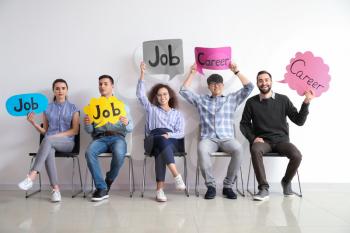 Young people holding speech bubbles with words JOB and CAREER indoors�