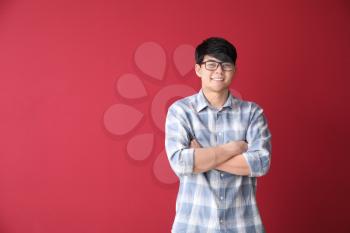 Portrait of young Asian businessman on color background�