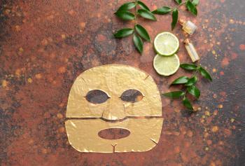 Sheet facial mask with essential oil on color background�