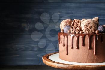 Sweet chocolate cake on color background�