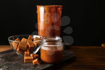 Composition with tasty caramel on table�