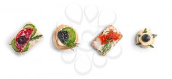 Assortment of tasty canapes on white background�