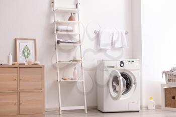 Interior of home laundry room with modern washing machine�