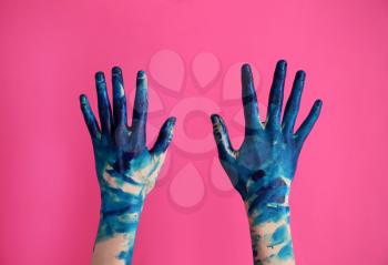 Painted female hands on color background�