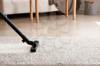 Brush of vacuum cleaner on carpet in room�