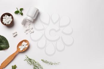 Composition with plant based pills on white background�