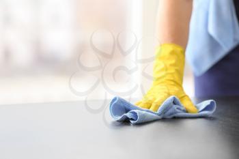 Male janitor cleaning table in office, closeup�