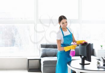 Female janitor cleaning office�