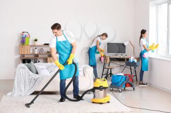 Team of janitors cleaning flat�