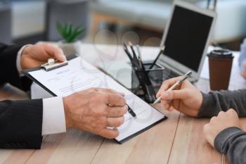 Man signing documents at notary public office�