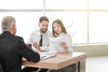 Couple meeting with notary public in office�