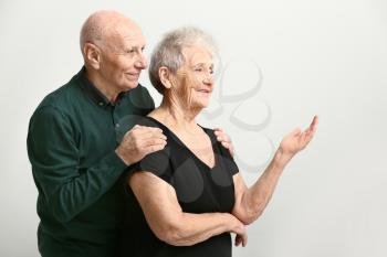 Portrait of senior couple on white background�