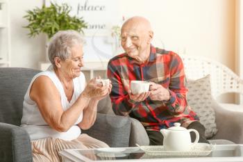 Portrait of senior couple drinking tea at home�