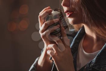 Beautiful female singer with microphone on stage, closeup�