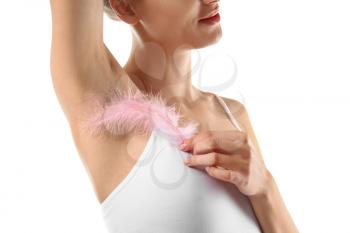Beautiful young woman with feather on white background. Epilation concept�