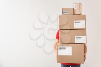 Delivery man with boxes on white background�