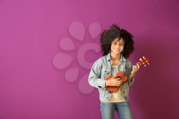 African-American girl with guitar against color background�